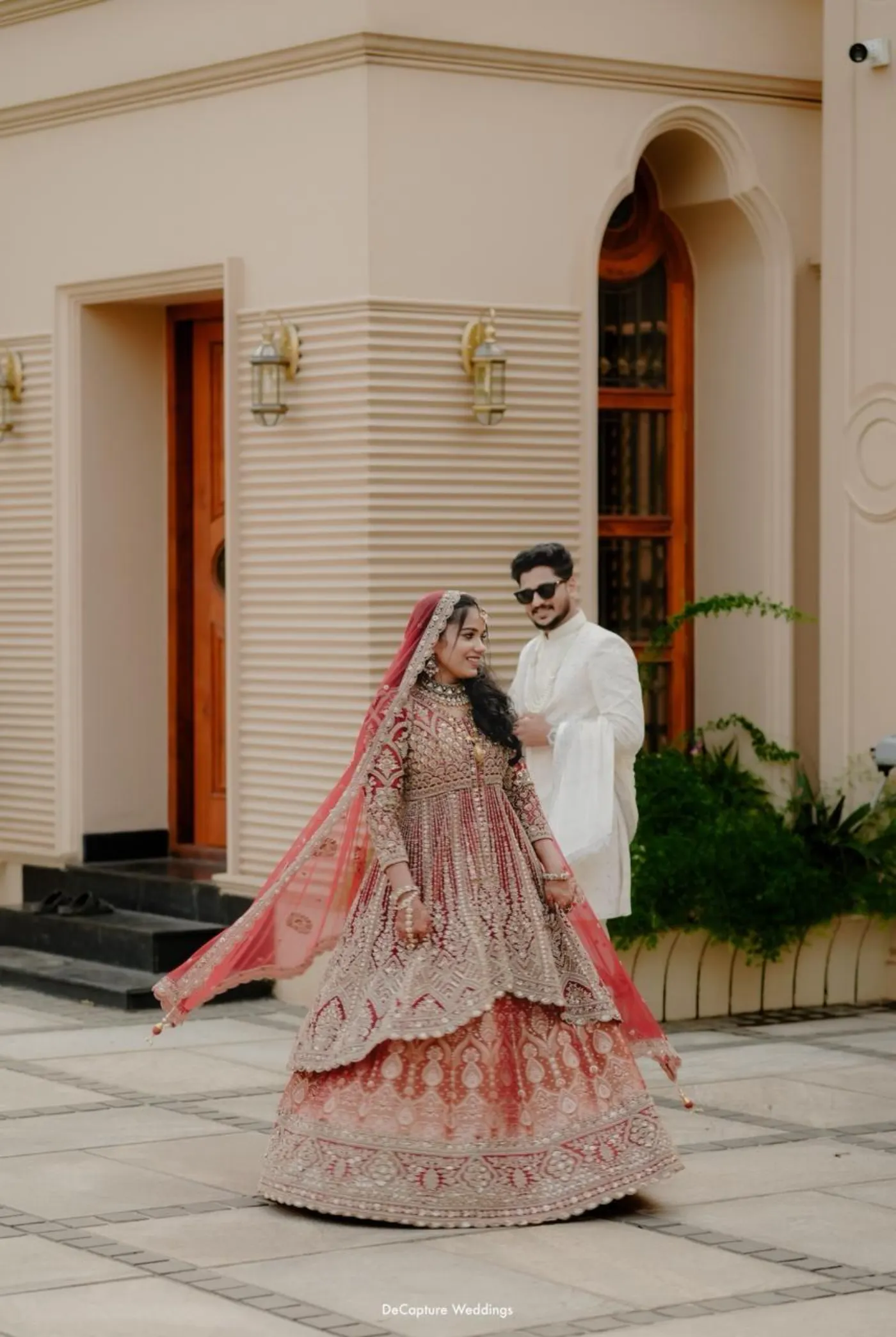 Mufeeda walking forward in her flowing bridal gown with Ashhar beside her.
